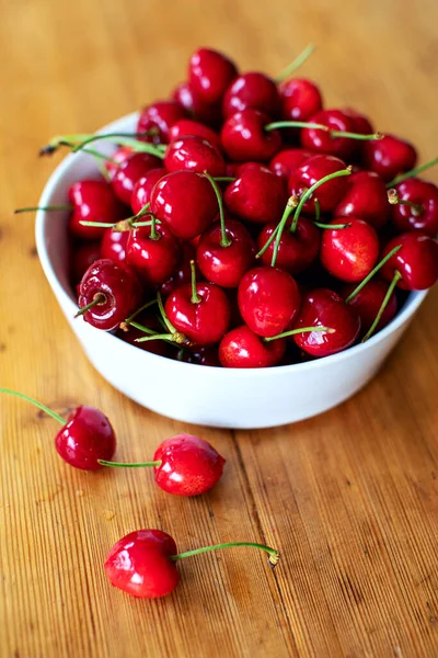 Fresh Cherries White Porcelain Bowl Three Them Lying Wooden Table — Stock Photo, Image