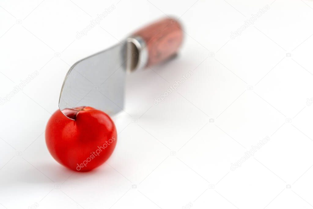minimalistic shoot of a tomato and a knife, shallow depth of field