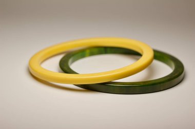 Close up abstract view of authentic bakelite (baekelite) bangle bracelets on white background, with copy space