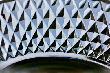 Macro abstract art texture background of beautiful sparkling lead crystal glass with hand-cut diamond facets, reflecting natural light