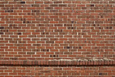 Antika tuğla duvar dokusu arka planda bozulmakta olan kırmızı tuğlalar pasaklı ve şık bir görünüme sahip, bir dizi çıkıntılı tuğla gösteriyor.