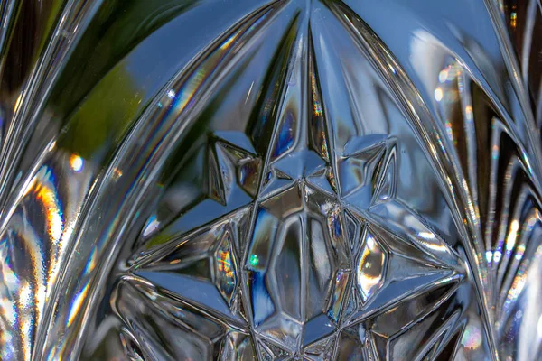 Macro art texture abstract background of shimmering lead crystal glass surface with star shape designs