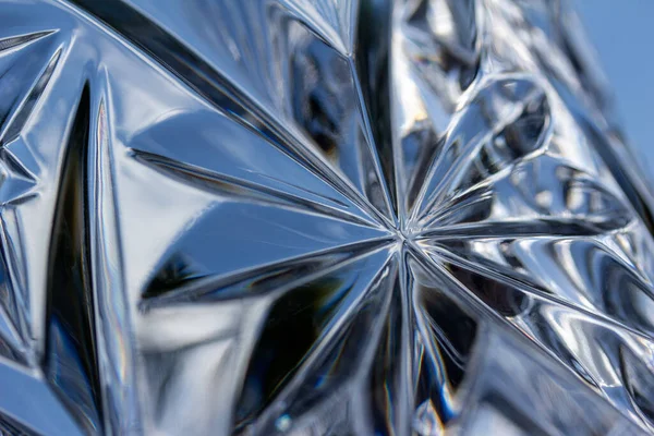 Macro art texture abstract background of shimmering lead crystal glass surface with starburst design