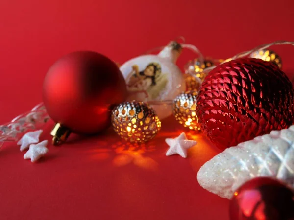 Group of different Christmas balls,toys and lanterns on a red background,Christmas and New Year celebration concept,Christmas card.Close-up,selective focus.