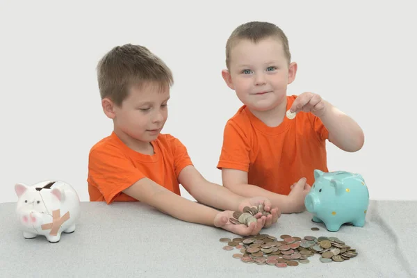 Two Little Boys Orange Shirts Table Counting Examining Coins Next — Stock Photo, Image