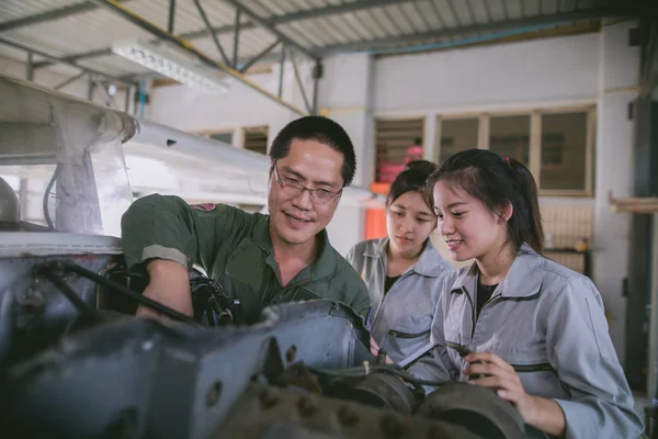 Asian student Engineers and technicians are repairing aircraft on class at university