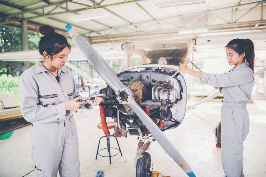 Asian student Engineers and technicians are repairing aircraft on class at university