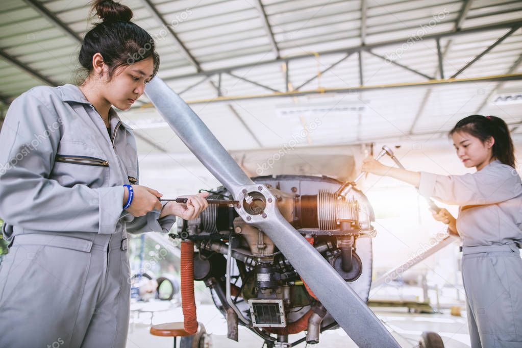 Asian student Engineers and technicians are repairing aircraft on class at university