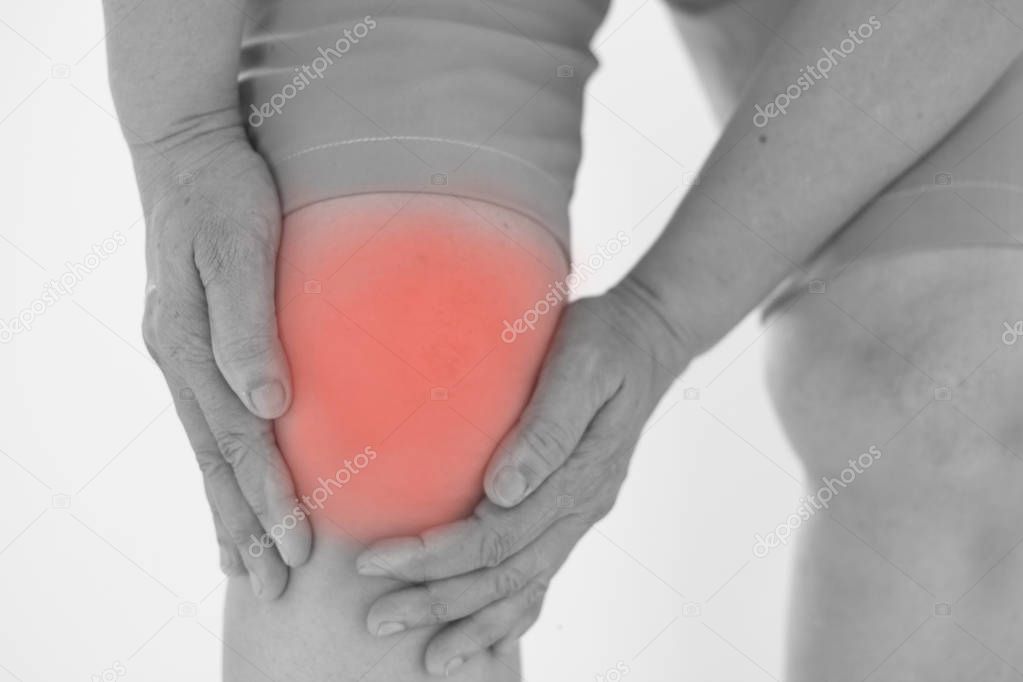 Soft focus of Old Asian women to knee injury on white background,black and white tone