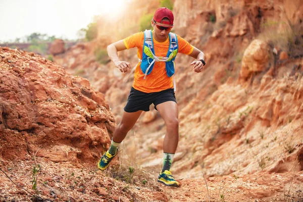 A man Runner of Trail . and athlete\'s feet wearing sports shoes for trail running in the mountains