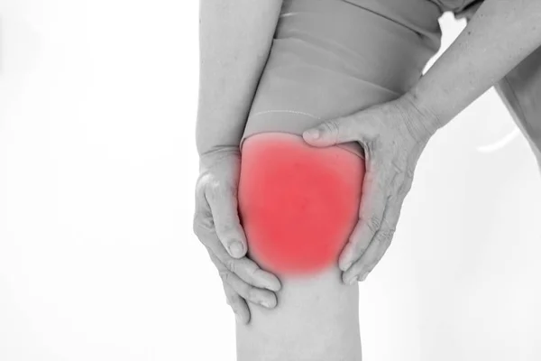Enfoque suave de las mujeres asiáticas de edad a la lesión de rodilla sobre fondo blanco — Foto de Stock