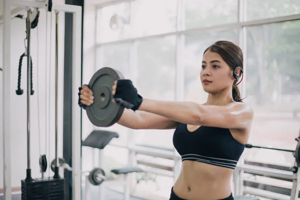 Hermosa mujer musculosa en forma ejercitando los músculos de construcción y ajuste — Foto de Stock