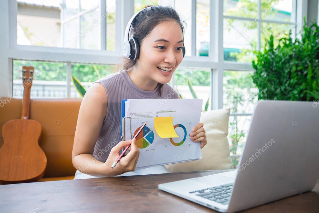 Asian businesswomen is using notebook computers and wear headphones for online meetings and working from home.