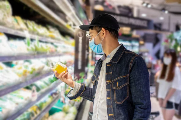 Asian men buy and shopping food  for hoarding in during the Covid outbreak