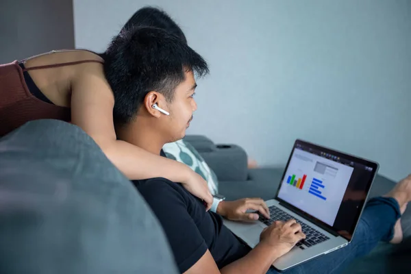아시아인젊은 집에서 일하는 이어폰 컴퓨터 노트북을 껴안고 집에서 온라인 미팅을 — 스톡 사진