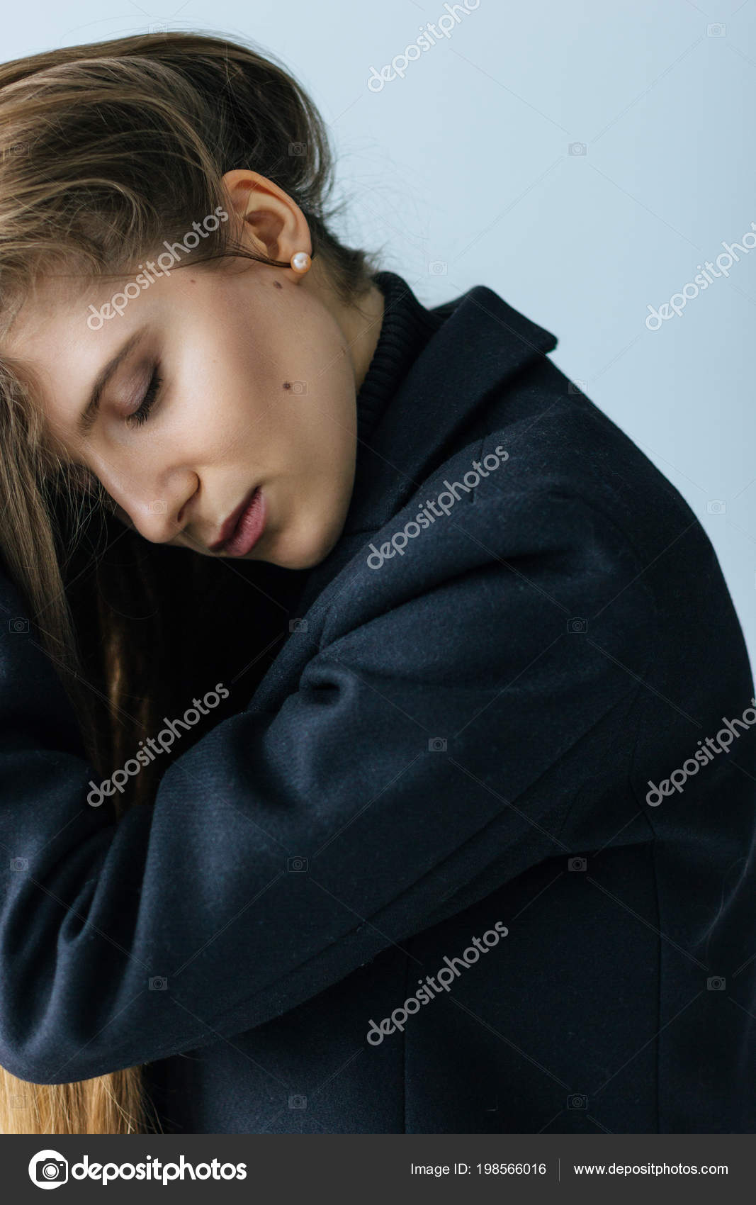 Young caucasian woman in black coat