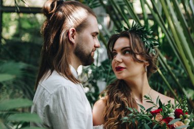 Beautiful wedding couple in botanical garden clipart