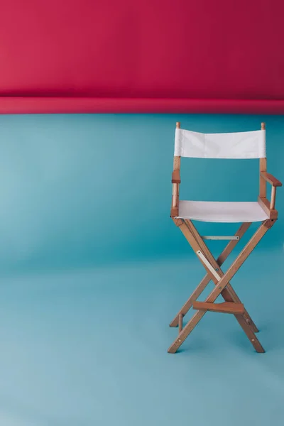 Director chair on blue and pink background