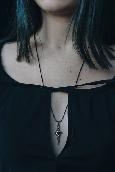 Woman wearing silver dagger pendant