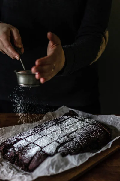 Woman Sprinkling Powdered Sugar Top Chocolate Brownie — Stock Photo, Image