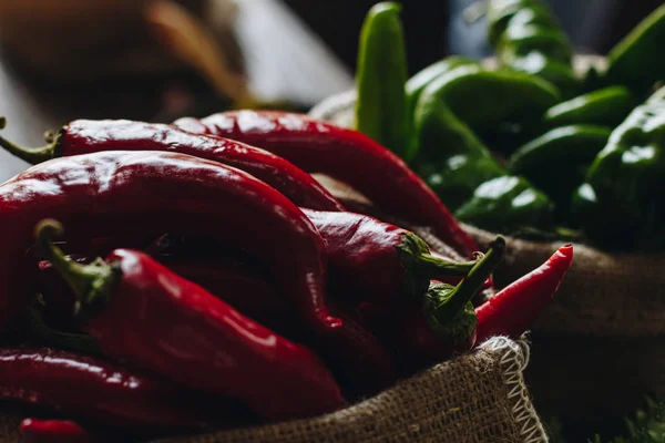 stock image Red and green hot peppers in linen bags