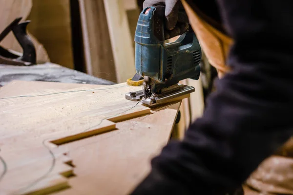 Carpenter working with an electric jigsaw — Stock Photo, Image