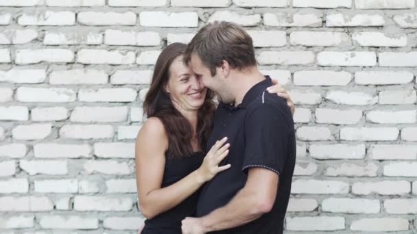 Man and woman kissing near the brick wall — Stock Video