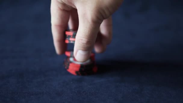 Poker. A male hand slowly lifts a stack of red poker chips up — Stock Video