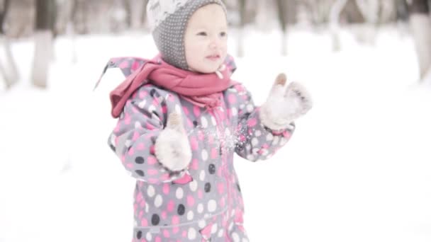 Little girl shakes off snow mittens — Stock Video