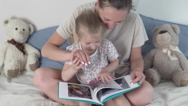 Mor och dotter titta igenom bilder i familjealbumet — Stockvideo