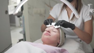 A serene beauty salon scene shows a woman enjoying a facial treatment amidst soft lighting and soothing music, emphasizing relaxation and selfcare