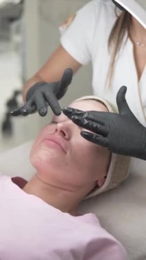 A woman is receiving a relaxing facial massage as part of a professional skincare treatment.