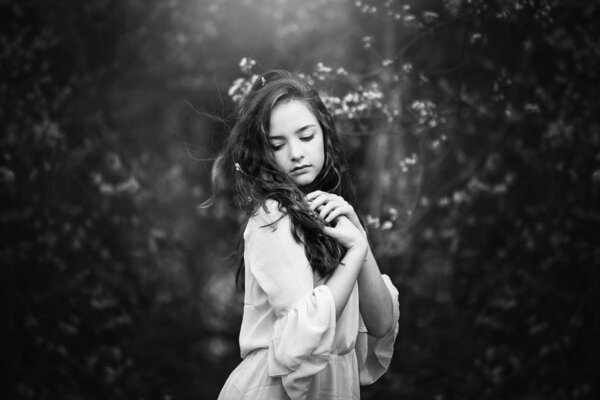 Teenage girl, nature background, black and white.