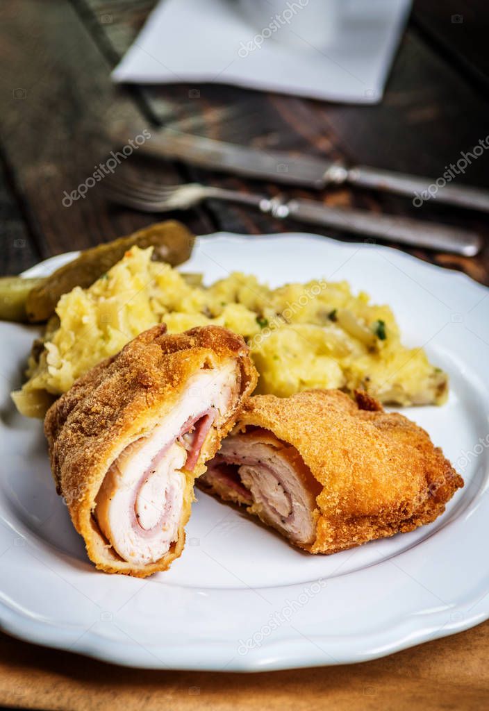 Traditional french cuisine chicken roll Cordon bleu or Gordon blue with cheese, ham and mashed potatoes