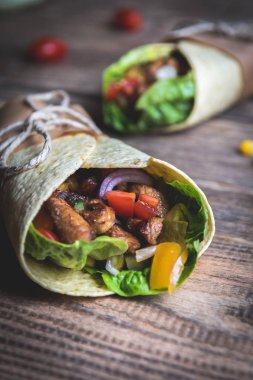 Geleneksel Meksika tortilla şal ahşap masa üzerinde ızgara tavuk eti ve sebze ile