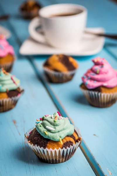 Chocolade Cupcake Met Gekleurde Roze Groen Crème Blauwe Tafel — Stockfoto