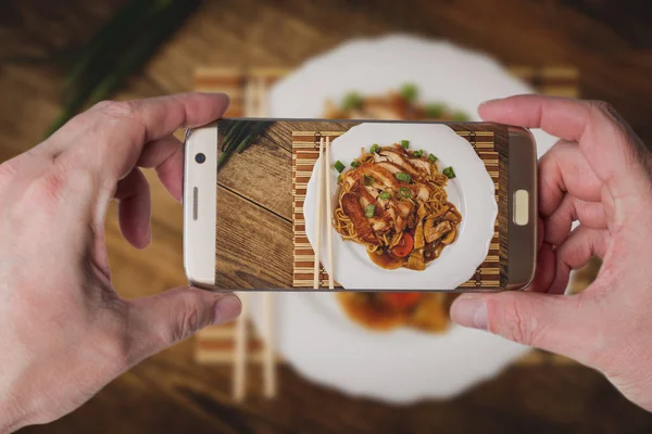 Man taking photo of Noodles with chicken — Stock Photo, Image