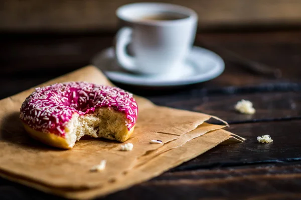 Bite a Pink donut with white sprinkle — Stock Photo, Image