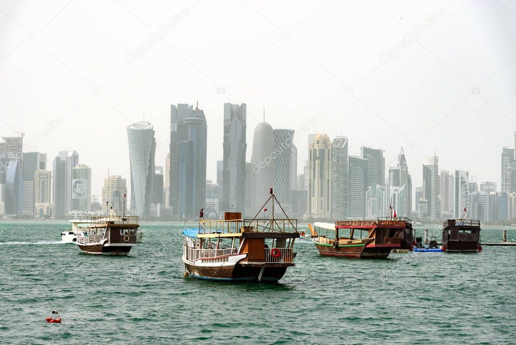 Doha skyline and passender boats at bay