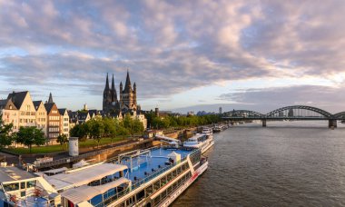 ship with authentic cologne architecture and distant bridge clipart