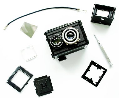 Old TLR camera, disassembled into parts, isolated. clipart