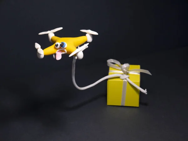 The drone Close up of quadrocopter. Drone with the parcel. With a box. On hands
