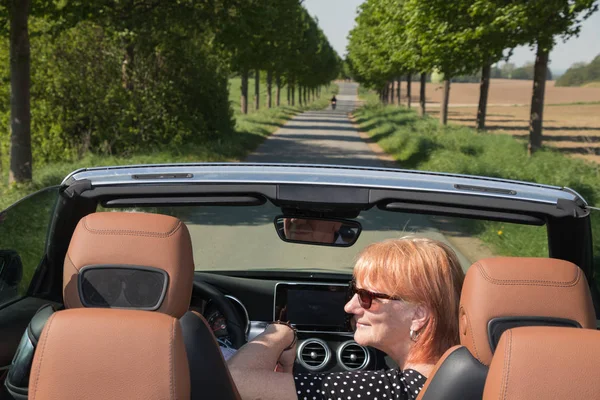 Older couple in love ride in convertible car