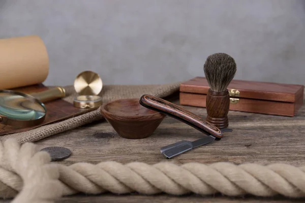 shaving accessories  - wooden razor with shaving brush and shaving foam on a rustic wooden background