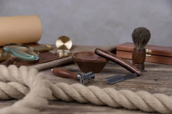 shaving accessories  - wooden razor with shaving brush and shaving foam on a rustic wooden background