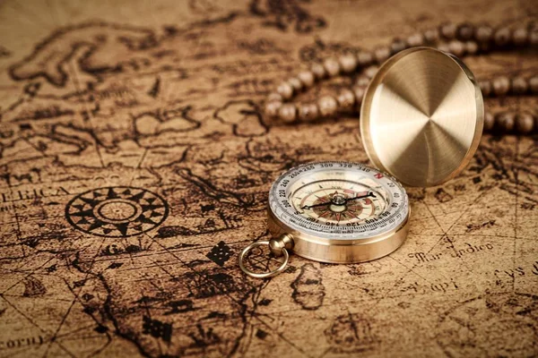 old vintage compass on old map - Explore the world-travel concept