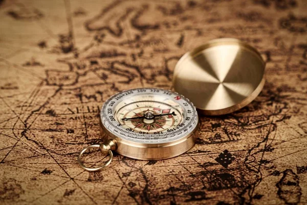old vintage compass on old map - Explore the world-travel concept