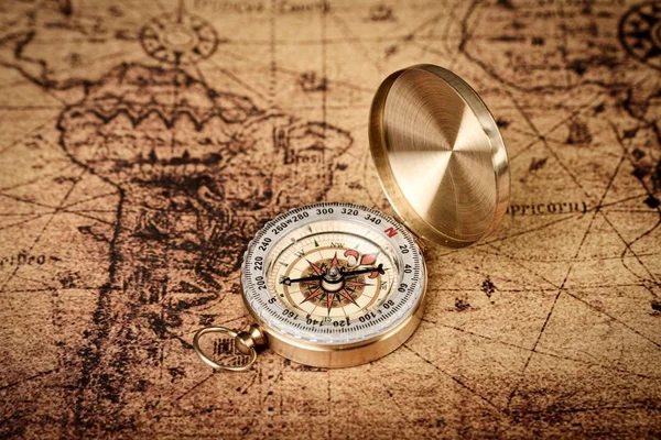 old vintage compass on old map - Explore the world-travel concept