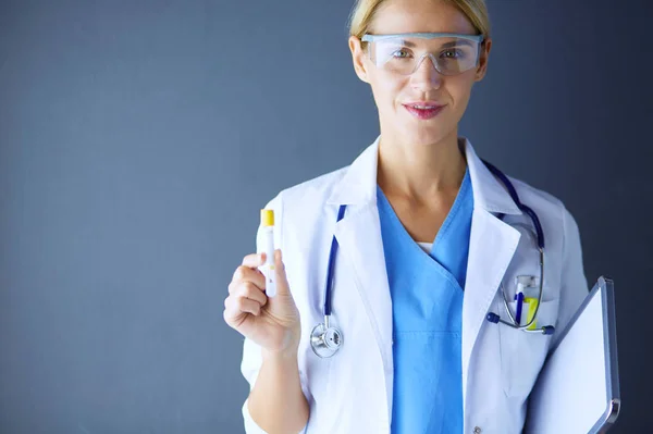 Kvinnlig läkare eller forskare med hjälp av ett provrör av klar lösning i ett labb eller laboratorium. — Stockfoto
