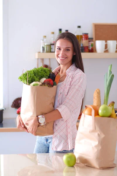 野菜の入った食料品の買い物袋を持っている若い女性。若い女性 — ストック写真